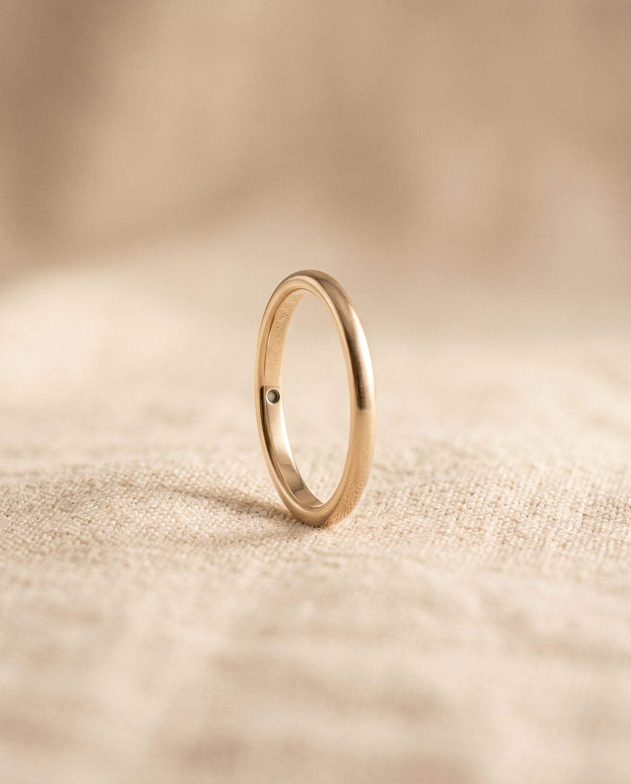 Charm ring, champagne titanium, on a dark surface